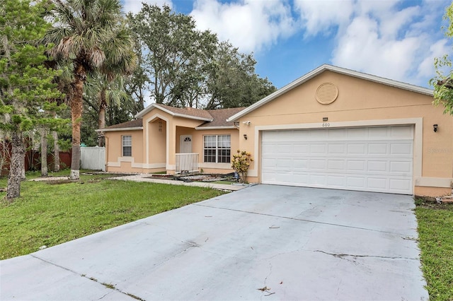 600 Regency Way, Kissimmee, FL 34758 - single story home with stucco siding, driveway, an attached garage, and a shingled roof