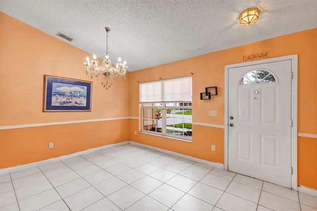600 Regency Way, Kissimmee, FL 34758 - foyer with a textured ceiling, a chandelier, and light tile patterned floors