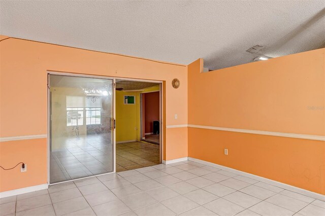 600 Regency Way, Kissimmee, FL 34758 - empty room featuring a textured ceiling and light tile patterned flooring