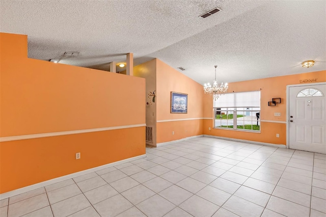 600 Regency Way, Kissimmee, FL 34758 - spare room with a chandelier, a textured ceiling, tile patterned flooring, and vaulted ceiling