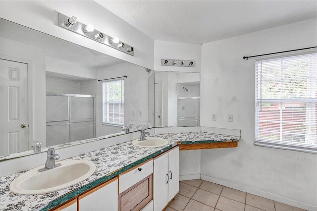 600 Regency Way, Kissimmee, FL 34758 - bathroom with a stall shower, tile patterned floors, and double vanity