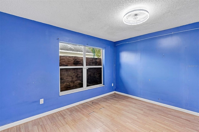 600 Regency Way, Kissimmee, FL 34758 - unfurnished room with a textured ceiling and wood finished floors
