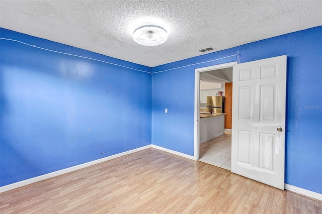 600 Regency Way, Kissimmee, FL 34758 - empty room featuring wood finished floors and a textured ceiling