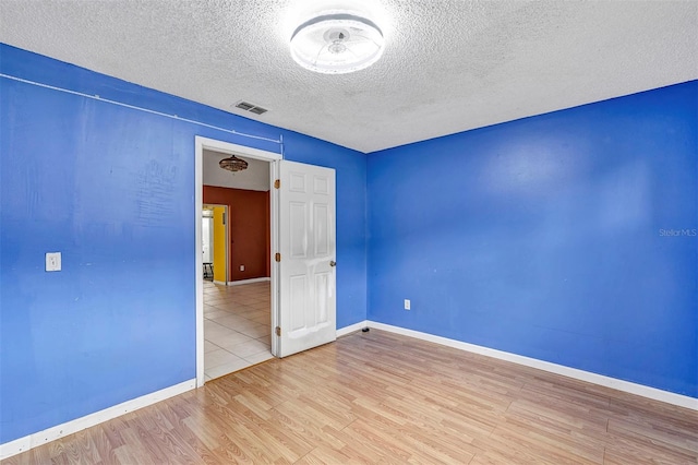 600 Regency Way, Kissimmee, FL 34758 - unfurnished room with wood finished floors and a textured ceiling