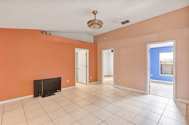 600 Regency Way, Kissimmee, FL 34758 - unfurnished room featuring lofted ceiling, light tile patterned floors, and a textured ceiling