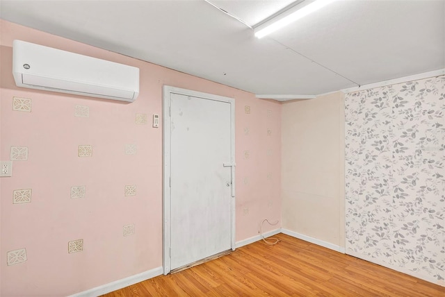 600 Regency Way, Kissimmee, FL 34758 - empty room featuring a wall mounted AC and light wood-style flooring
