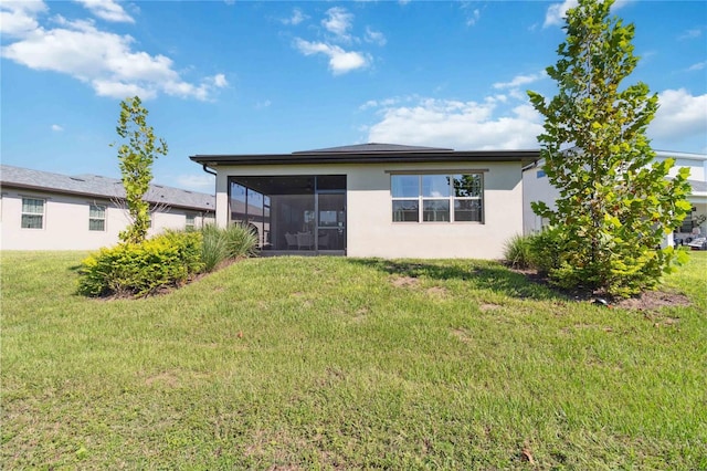 3224 Oxbow Ct, Harmony, FL 34773 - back of house featuring a sunroom, stucco siding, and a lawn