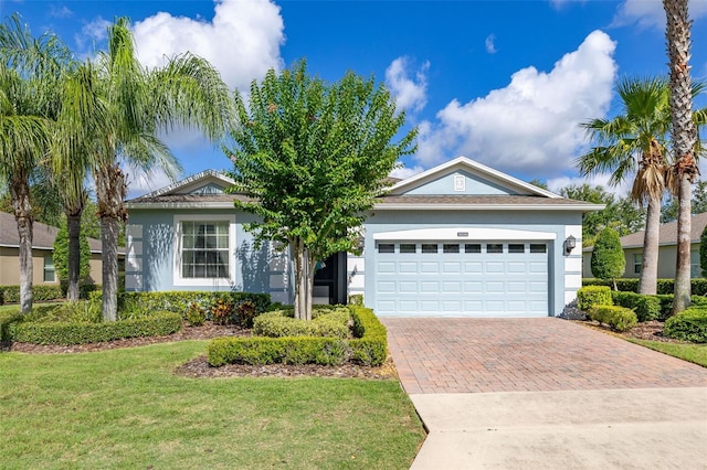 3606 Solana Cir, Clermont, FL 34711 - ranch-style house featuring decorative driveway, a front lawn, stucco siding, and a garage