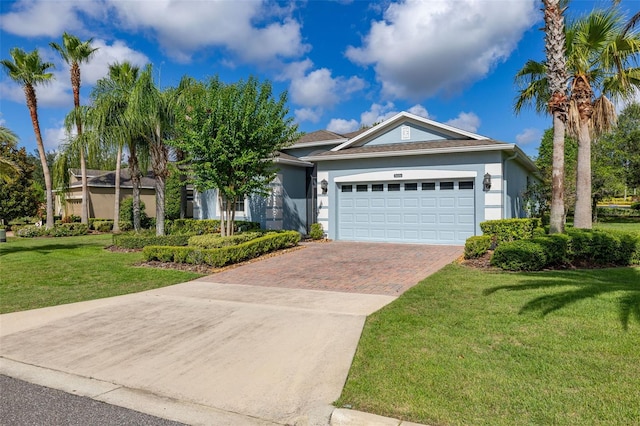 3606 Solana Cir, Clermont, FL 34711 - view of front of house with stucco siding, decorative driveway, a garage, and a front yard