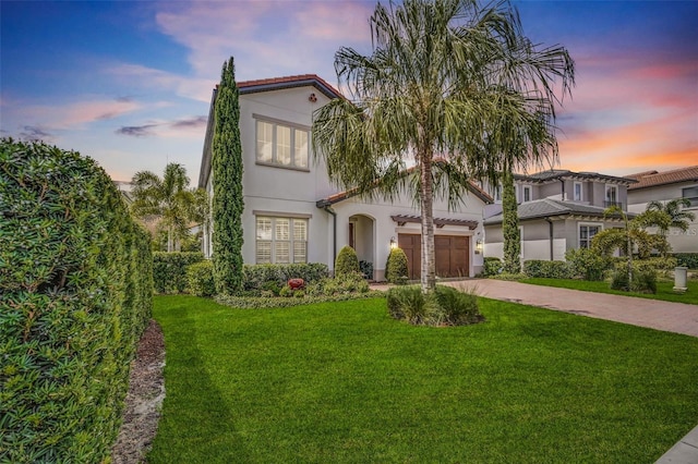 10836 Royal Cypress Way, Orlando, FL 32836 - mediterranean / spanish-style house featuring concrete driveway, a lawn, stucco siding, an attached garage, and a tiled roof