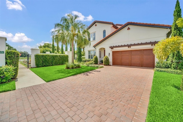 10836 Royal Cypress Way, Orlando, FL 32836 - mediterranean / spanish-style home featuring a gate, a garage, decorative driveway, stucco siding, and a tiled roof