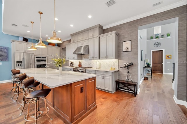 10836 Royal Cypress Way, Orlando, FL 32836 - kitchen featuring under cabinet range hood, stainless steel appliances, baseboards, a breakfast bar, and backsplash