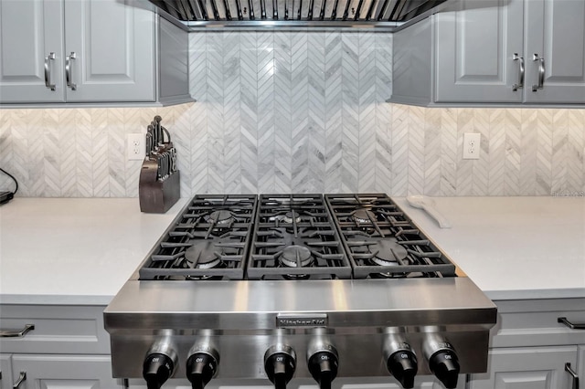 10836 Royal Cypress Way, Orlando, FL 32836 - kitchen featuring stove, decorative backsplash, and gray cabinetry