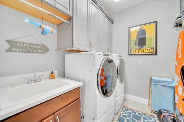 10836 Royal Cypress Way, Orlando, FL 32836 - laundry area featuring separate washer and dryer, cabinet space, light tile patterned flooring, and baseboards