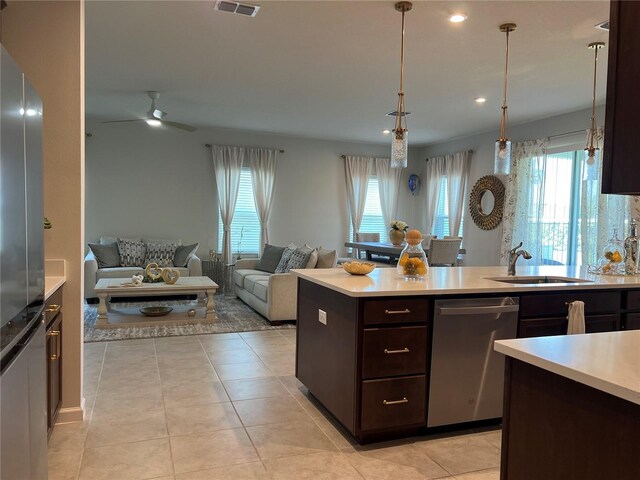 1896 Basenji Dr, Lake Alfred, FL 33850 - kitchen with stainless steel appliances, dark brown cabinets, light countertops, plenty of natural light, and recessed lighting