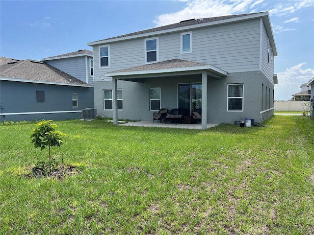 1896 Basenji Dr, Lake Alfred, FL 33850 - rear view of house featuring cooling unit, a patio, a yard, roof with shingles, and stucco siding