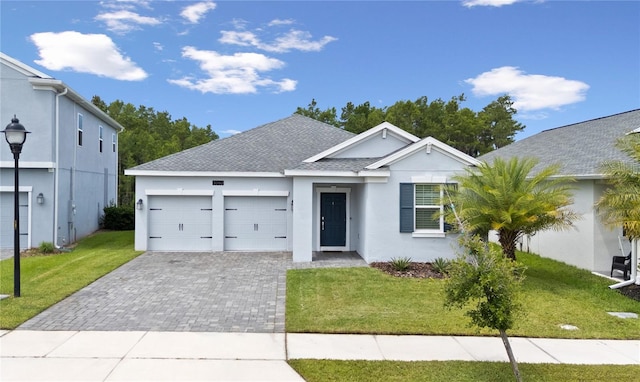 3052 Prelude Ln, Kissimmee, FL 34746 - single story home with a shingled roof, stucco siding, a garage, decorative driveway, and a front lawn