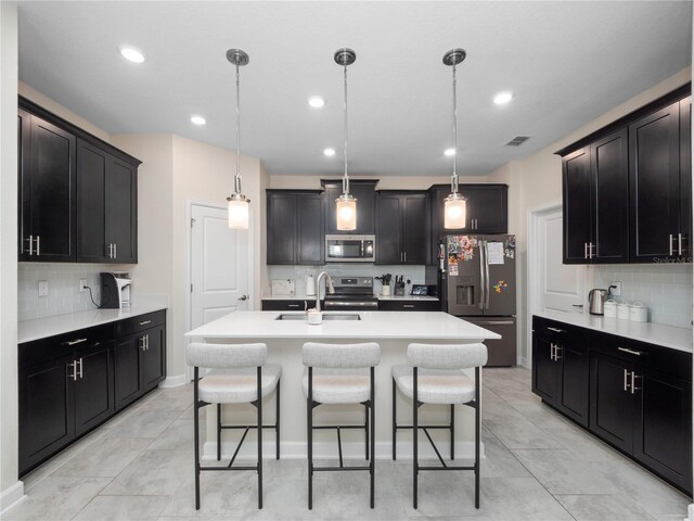 3052 Prelude Ln, Kissimmee, FL 34746 - kitchen with stainless steel appliances, a sink, tasteful backsplash, a kitchen breakfast bar, and recessed lighting