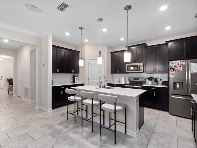 3052 Prelude Ln, Kissimmee, FL 34746 - kitchen with stainless steel appliances, a sink, tasteful backsplash, a kitchen breakfast bar, and crown molding