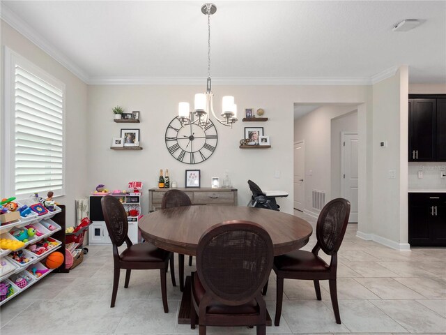 3052 Prelude Ln, Kissimmee, FL 34746 - dining area featuring crown molding and a chandelier