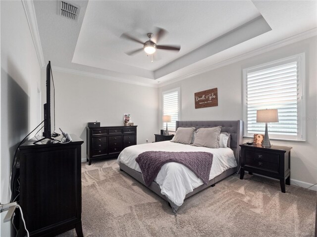 3052 Prelude Ln, Kissimmee, FL 34746 - bedroom featuring a tray ceiling, light colored carpet, ornamental molding, baseboards, and ceiling fan