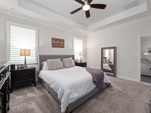 3052 Prelude Ln, Kissimmee, FL 34746 - bedroom with a tray ceiling, light carpet, ornamental molding, baseboards, and a ceiling fan
