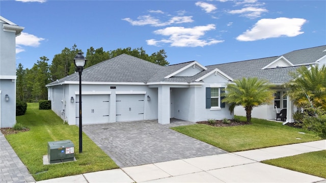 3052 Prelude Ln, Kissimmee, FL 34746 - single story home featuring a shingled roof, a garage, a front lawn, stucco siding, and decorative driveway