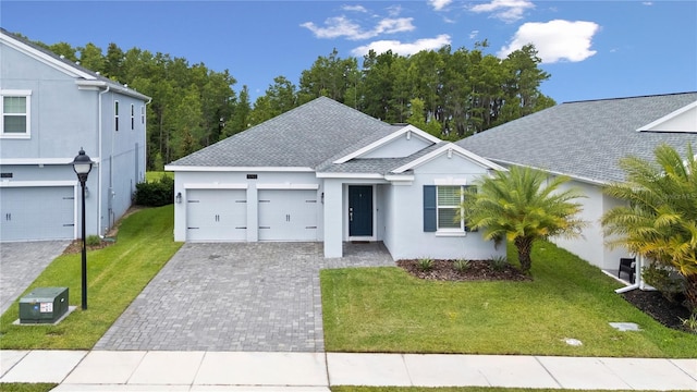 3052 Prelude Ln, Kissimmee, FL 34746 - single story home featuring stucco siding, roof with shingles, decorative driveway, and a front lawn
