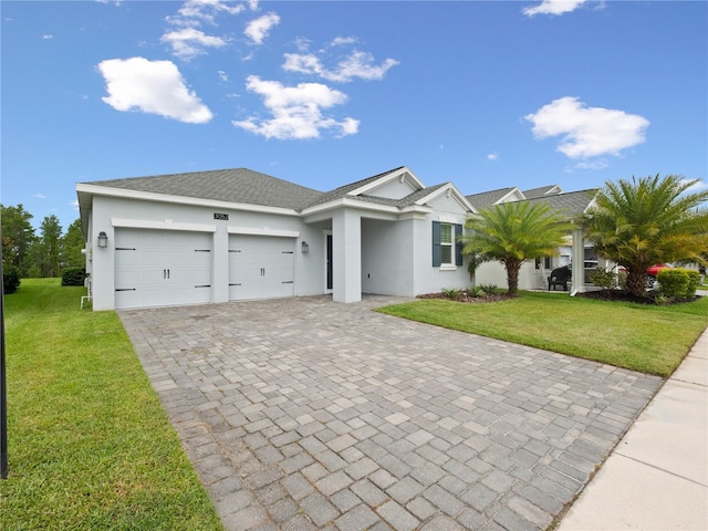 3052 Prelude Ln, Kissimmee, FL 34746 - view of front facade with a garage, stucco siding, a front lawn, and decorative driveway