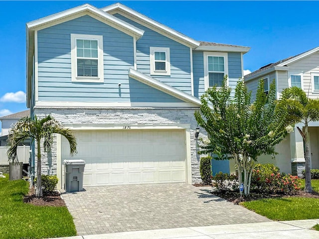 1876 Summer Dr, Davenport, FL 33897 - traditional-style house featuring a garage and decorative driveway