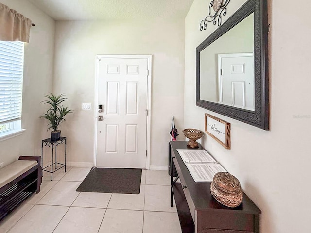 1876 Summer Dr, Davenport, FL 33897 - foyer entrance with light tile patterned floors and baseboards