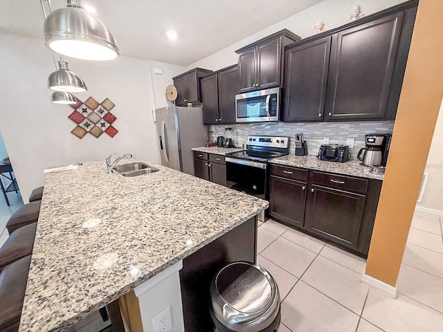 1876 Summer Dr, Davenport, FL 33897 - kitchen featuring appliances with stainless steel finishes, a sink, and a kitchen breakfast bar