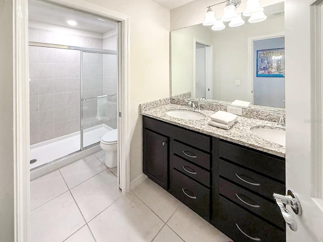 1876 Summer Dr, Davenport, FL 33897 - full bathroom with toilet, double vanity, a stall shower, tile patterned floors, and baseboards