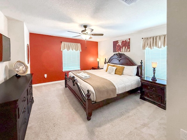 1876 Summer Dr, Davenport, FL 33897 - bedroom with light carpet, ceiling fan, baseboards, and a textured ceiling