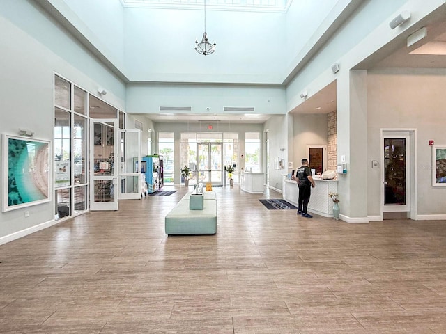 1876 Summer Dr, Davenport, FL 33897 - living area featuring a high ceiling, baseboards, and wood finished floors