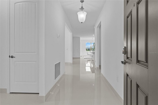 17795 Blazing Star Cir, Clermont, FL 34714 - hall with light tile patterned floors and baseboards