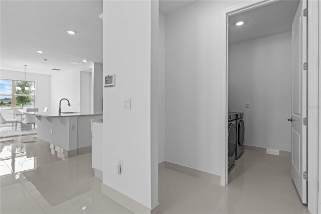17795 Blazing Star Cir, Clermont, FL 34714 - hall with washing machine and clothes dryer, recessed lighting, baseboards, and a sink