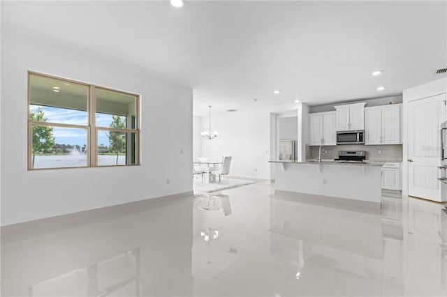 17795 Blazing Star Cir, Clermont, FL 34714 - kitchen with stainless steel microwave, electric range, a sink, recessed lighting, and white cabinets