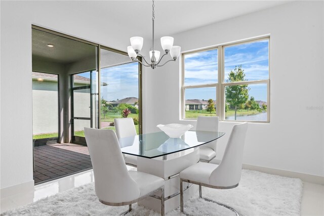17795 Blazing Star Cir, Clermont, FL 34714 - dining room with a chandelier and baseboards
