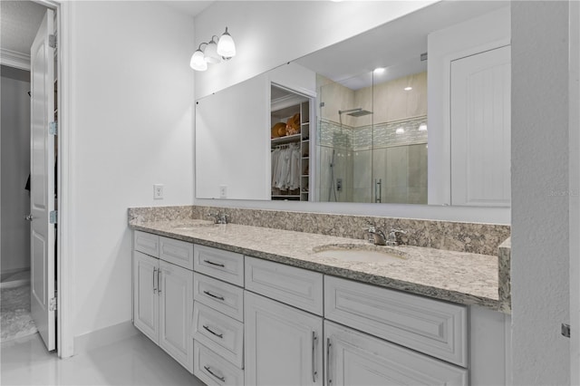 17795 Blazing Star Cir, Clermont, FL 34714 - bathroom with a stall shower, double vanity, a spacious closet, and baseboards