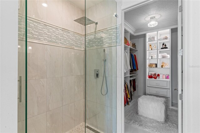 17795 Blazing Star Cir, Clermont, FL 34714 - bathroom with a stall shower, crown molding, a spacious closet, and a textured ceiling