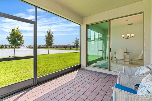 17795 Blazing Star Cir, Clermont, FL 34714 - sunroom / solarium with a water view, a chandelier, and plenty of natural light