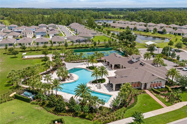 17795 Blazing Star Cir, Clermont, FL 34714 - bird's eye view of a pool, a heavily wooded area, and a large body of water