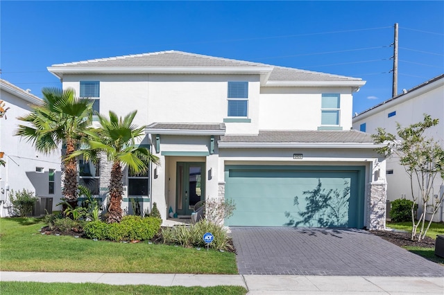 2623 Calistoga Ave, Kissimmee, FL 34741 - view of front of home with a garage, decorative driveway, and stucco siding