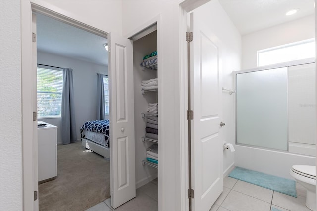 2623 Calistoga Ave, Kissimmee, FL 34741 - ensuite bathroom featuring plenty of natural light, toilet, enclosed tub / shower combo, and tile patterned floors