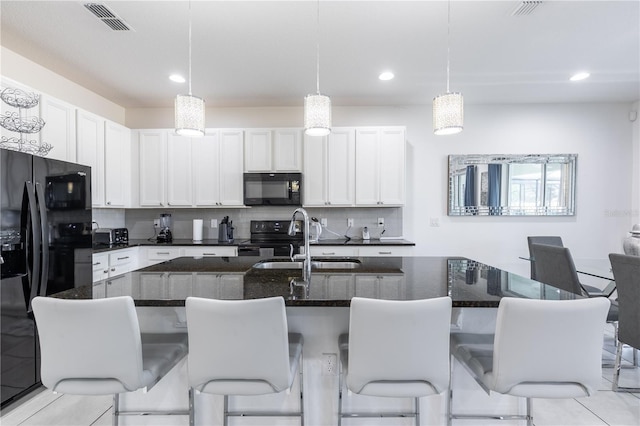 2623 Calistoga Ave, Kissimmee, FL 34741 - kitchen featuring black appliances, a sink, tasteful backsplash, recessed lighting, and white cabinetry