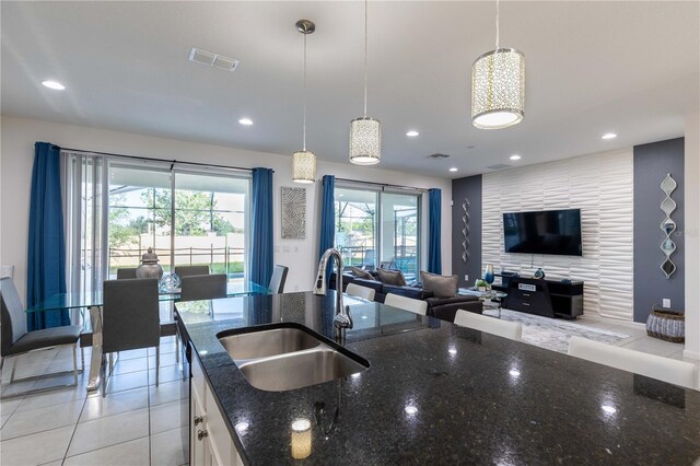 2623 Calistoga Ave, Kissimmee, FL 34741 - kitchen featuring a sink, open floor plan, dark stone counters, white cabinets, and recessed lighting