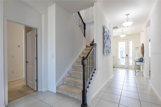 2623 Calistoga Ave, Kissimmee, FL 34741 - entryway featuring stairs, arched walkways, baseboards, and light tile patterned floors