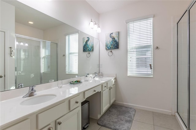 2623 Calistoga Ave, Kissimmee, FL 34741 - bathroom with double vanity, a stall shower, tile patterned floors, and baseboards
