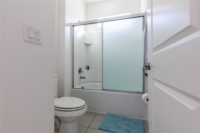 2623 Calistoga Ave, Kissimmee, FL 34741 - bathroom with toilet, tile patterned flooring, and shower / bath combination with glass door